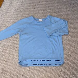 Athleta Light Blue Long Sleeve Performance Tee with 'OWN YOUR POWER' Hem